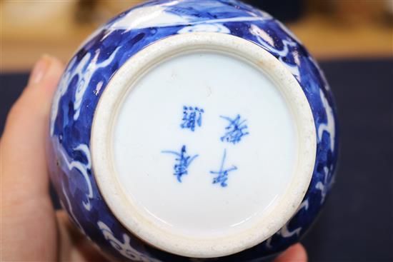 A blue and white vase painted with dragons and birds